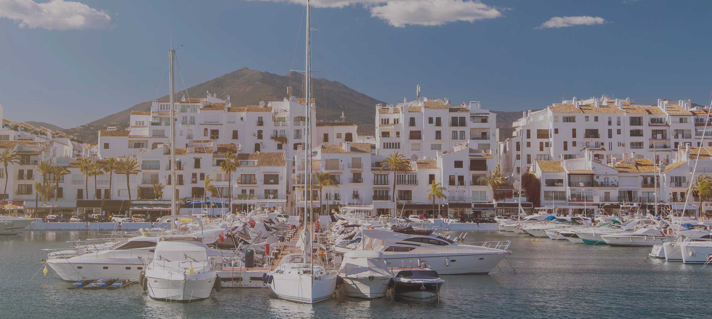 Marbella harbor with boats in the front of the houses