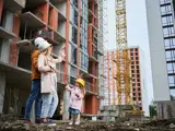 Couple with a child on a construction site