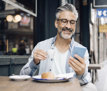 man with phone drinking cofee