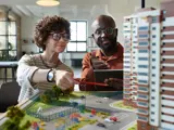 Man and woman looking at a model of a new construction