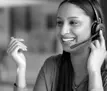 Happy young woman talking to a customer